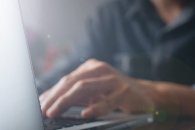 Hands Typing on Keyboard