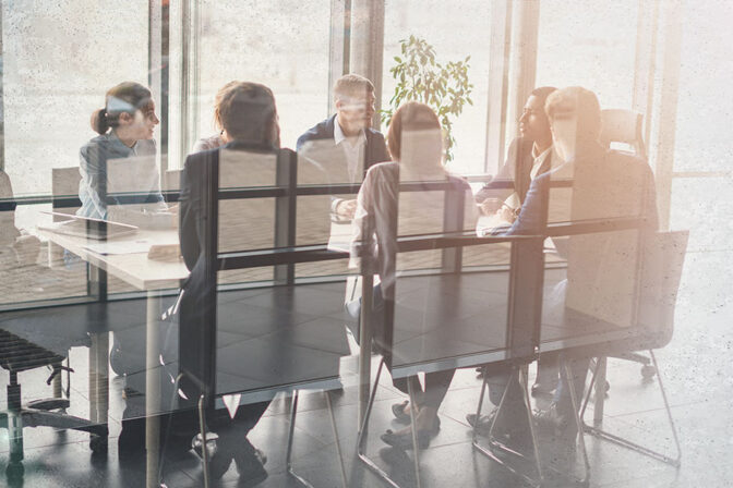 Employees at Conference Table Conducting Tabletop Exercise