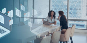 Two Women Talking in a Meeting at a Table