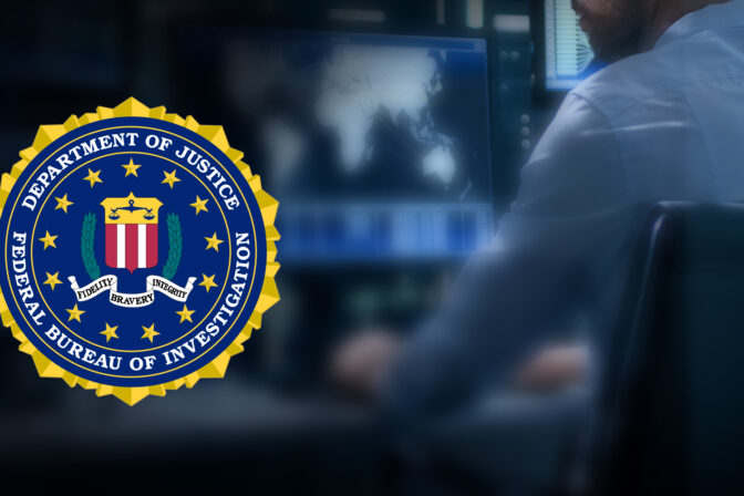 FBI Symbol Over a Man Working on a Computer