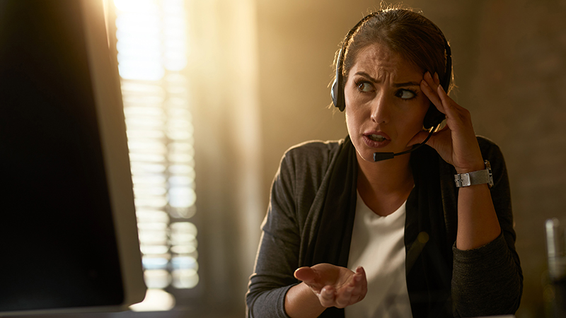 Woman confused on a phone call as a threat actor attempts to use AI phishing tools to infiltrate an organization.