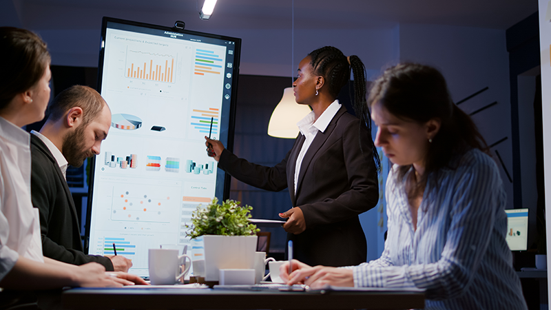 A group of professionals conducting a third-party risk assessment in an office.