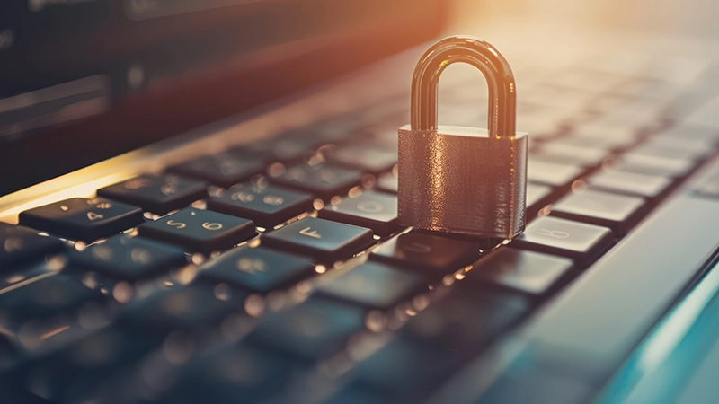 A close-up image of a padlock resting on a computer keyboard, symbolizing cybersecurity and protection. The image highlights the importance of vulnerability scanning and penetration testing in securing digital systems from potential threats.