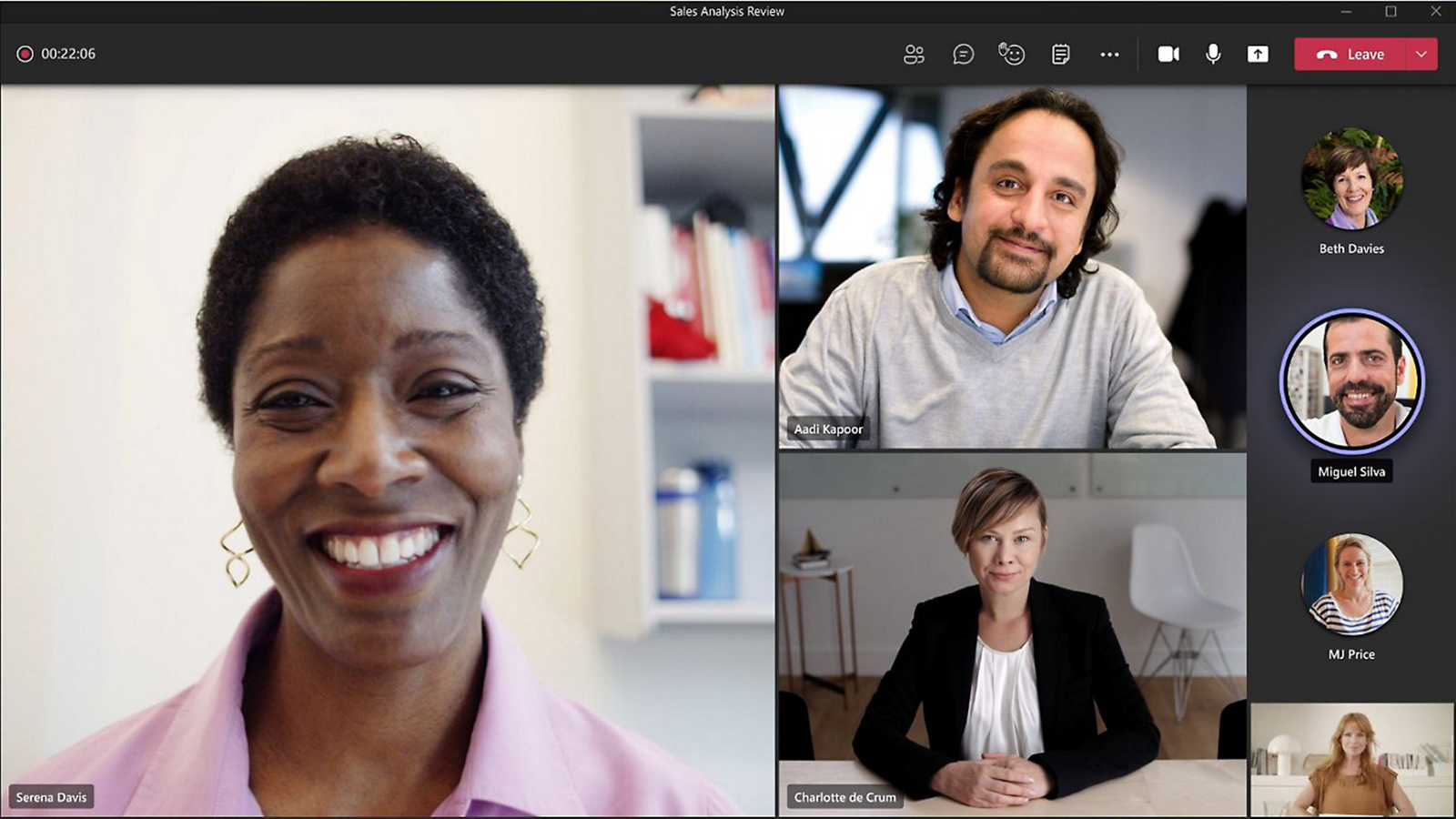 A Microsoft Teams meeting interface with a primary speaker on the main screen, smiling. Smaller participant video feeds appear on the right side of the screen.