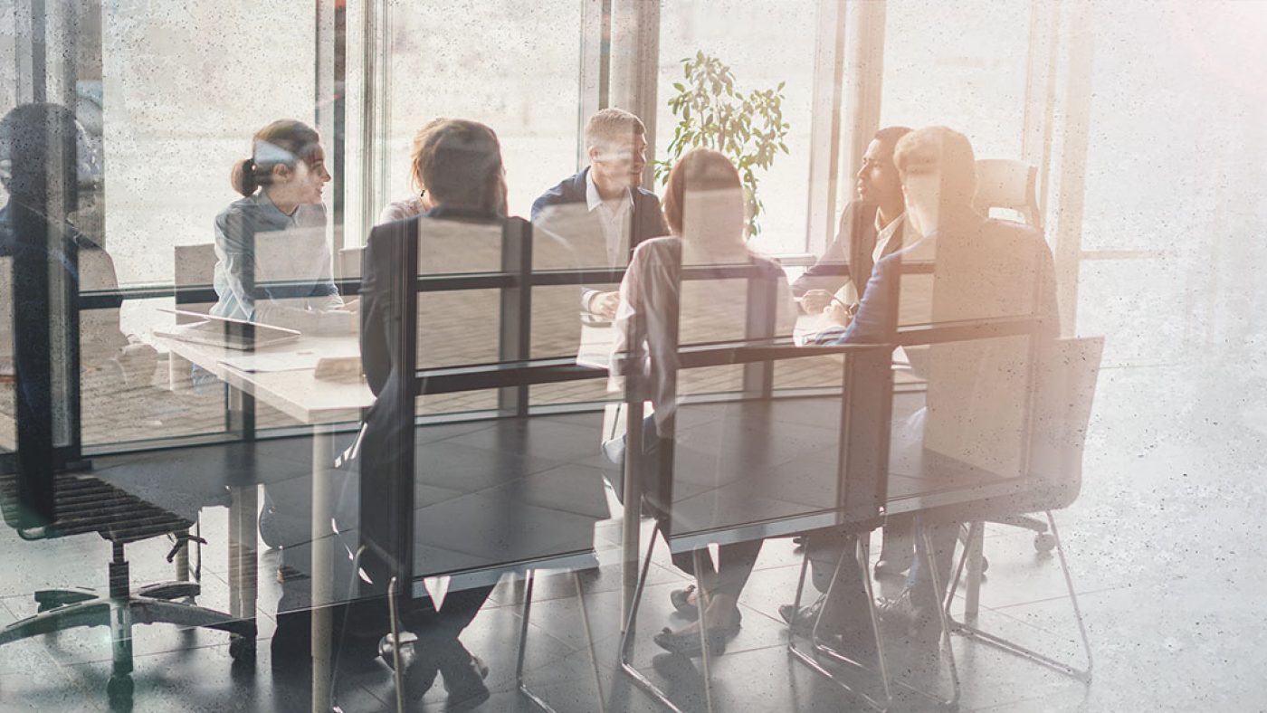 Employees at Conference Table Conducting Tabletop Exercise