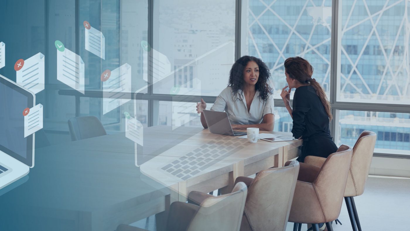 Two Women Talking in a Meeting at a Table